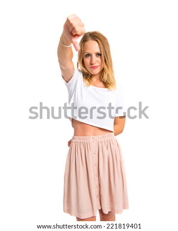 Girl doing a bad signal over white background