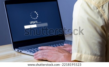 Software update or operating system upgrade to keep the device up to date with added functionality in new version and improve security. Updating progress bar on computer screen. Installing app patch. Royalty-Free Stock Photo #2218195523