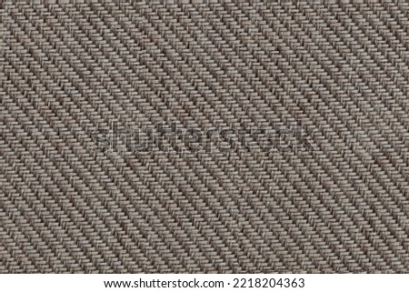Texture of beige fabric of large herringbone weave.