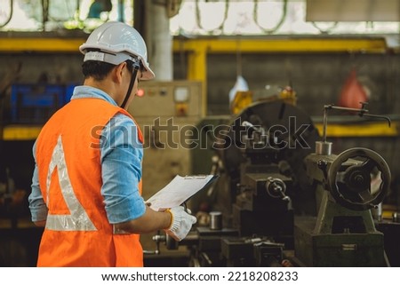Industry male engineer worker safety check machine service fix setup working in lathe steel metal factory 