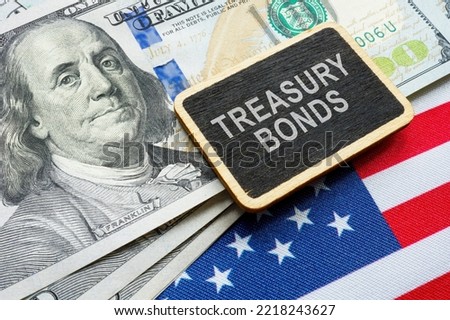 Treasury bonds concept. American flag, dollars and plate. Royalty-Free Stock Photo #2218243627