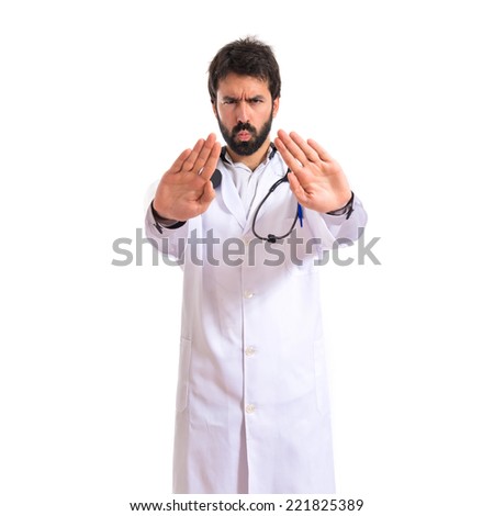 Doctor making stop sign over white background
