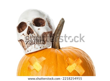 Jack-O-Lantern pumpkin with human skull on white background
