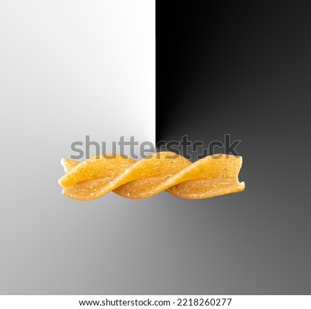 A single piece of fusilli pasta makes a composite picture edited in Photoshop.
