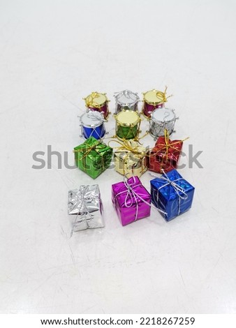 mini gift wrap decorations in mixed colors drawn on white background