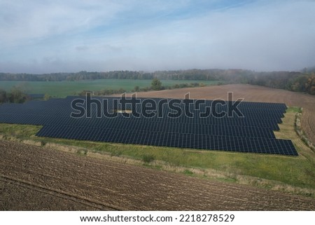 Modern solar power plant, photovoltaic panels green energy electricity production,new power plant,European energy crisis 2022, green deal,Czech republic,European Union,aerial panorama from foggy cloud