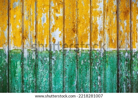Group of vertical wooden panels painted yellow and green. Vintage effect.