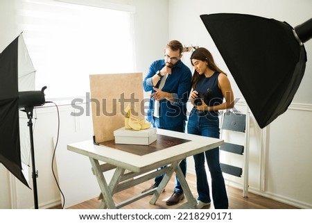 Professional photographers at the studio working as a teamwork to do a fashion photo shoot 