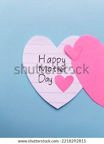 Handwritten happy mother's day and symbol of love.