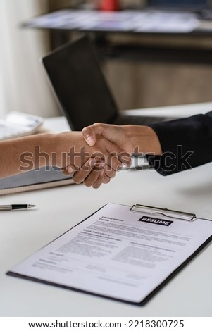 Close-up of business people shaking hands with job seekers, female managers who have successfully settled on new applicants. Professional staff with greeting applicants