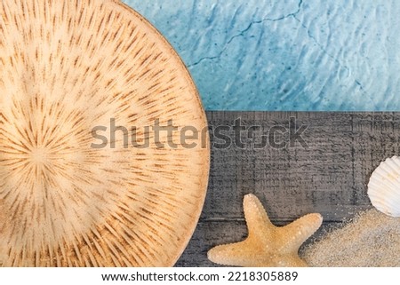 Exotic dish seen from above on a wooden floor above a pool with shells. Ambiance vacation in summer.	