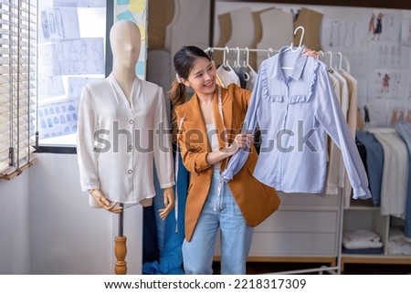 Young professional clothes fashion textile creative thinking designer working with puppet model to check cloth match design in studio office room