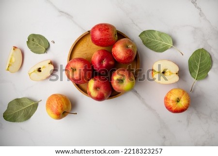 Fresh red and yellow apples on plate healthy food on light surface top view