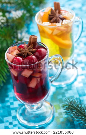 Christmas mulled wine and apple cider on a blue background, top view, vertical