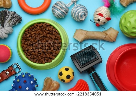 Flat lay composition with different pet toys and accessories on light blue background