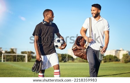 Soccer, training and friends walking on field after practice, match and football game. Diversity, fitness and men happy after exercise, workout and playing sports together carrying gear, ball and bag Royalty-Free Stock Photo #2218359983