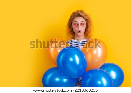 party woman with balloon in sunglasses. surprised woman hold party balloons in studio.
