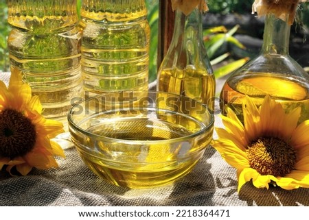 Organic sunflower oil and flowers on fabric, closeup
