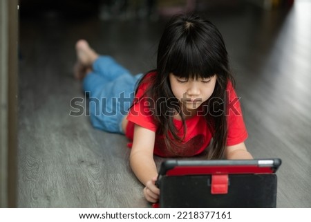 kid watching tablet, child addicted cartoon
