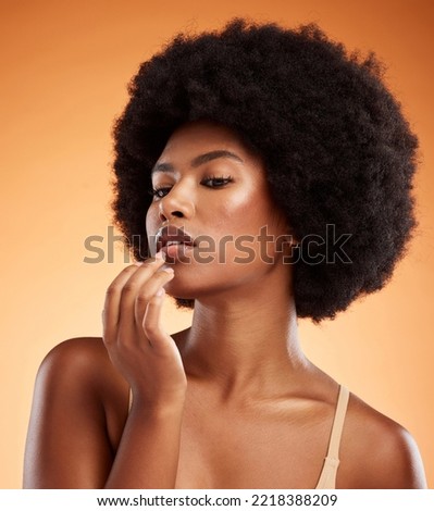 Model woman with lip balm makeup in studio, portrait with skincare product advertising or natural cosmetic on face. Lip gloss on mouth, beauty on orange background or moisturizer cream lipstick Royalty-Free Stock Photo #2218388209