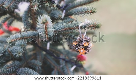 Handmade natural pine cone decoration on Christmas tree. Diy ideas for children. Environment, reuse, recycle, upcycling and zero waste concept. Selective focus. Banner with copy space