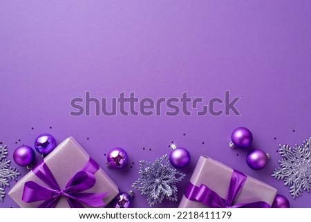 Christmas Eve concept. Top view photo of lilac gift boxes with ribbon bows flower ornaments violet baubles and confetti on isolated purple background with empty space Royalty-Free Stock Photo #2218411179
