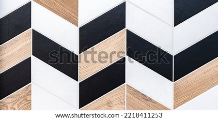 Abstract geometric pattern of different textures ceramic tiles with rhomboid shape in black and white and natural wood look.