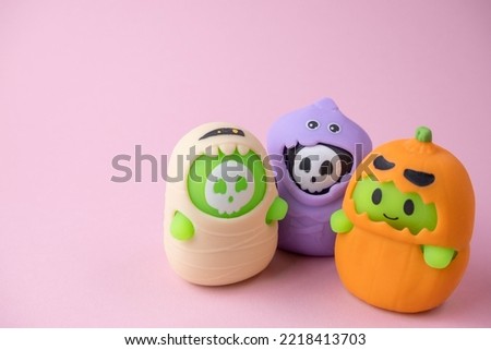 children's monsters for Halloween on pink and orange background , the concept of a children's holiday