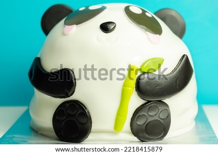 Layered biscuit cake in the shape of a panda decorated for party, sweet dessert, funny