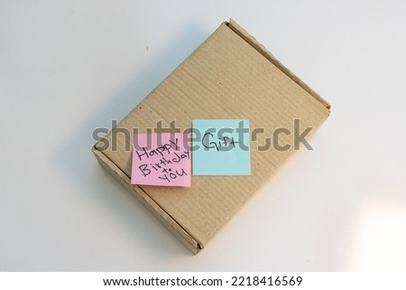 Parcel box with a text note of happy birthday and gift