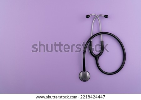 A stethoscope against a purple backgroundA stethoscope against a purple background