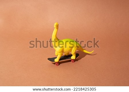 Plastic toy dinosaur standing on a skateboard. Brown background. Minimal design.