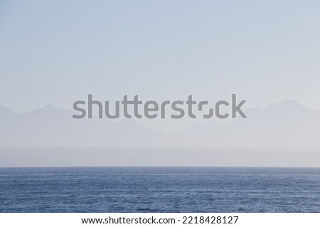 Seascape Horizon With Mountain Range In The Distance