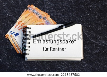Notepad with the German text  Entlastungspaket für Rentner, German aid program during the energy crisis.
Entlastungspaket für Rentner translates to relief package for pensioners. Royalty-Free Stock Photo #2218437583