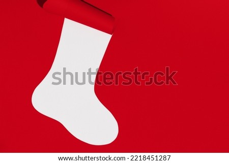 Christmas sock on white and red background. Space for text. Mockup. High quality photo