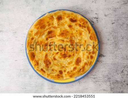 Ceispy simple paratha served in a plate isolated on background top view of indian and pakistani desi food Royalty-Free Stock Photo #2218453551