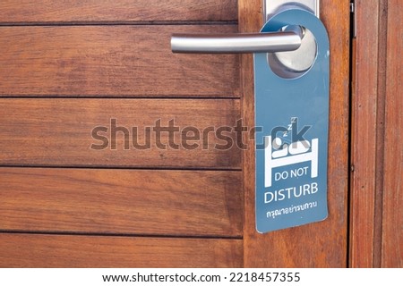 Do not disturb sign at the front wood door at the resort. Do not cleaning the room. Need private time.