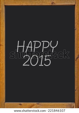 Happy 2015 written on a small blackboard with a wooden frame