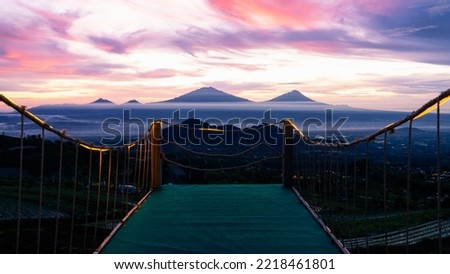 Beautiful reddish orange sunrise sky with mountain range on the garden - View from Mangli Sky View on slope  Sumbing Mountain