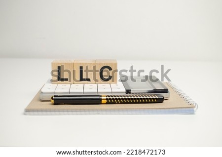 On wooden blocks with the inscription - LIMITED LIABILITY COMPANY Royalty-Free Stock Photo #2218472173