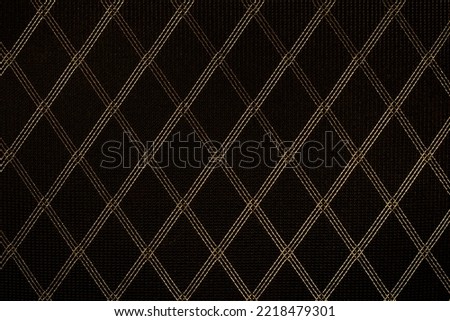 Black fabric with a gold pattern.