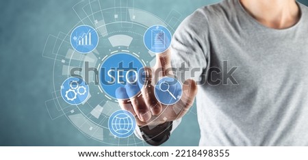 SEO and icons on virtual screen. Man tapping on the screen