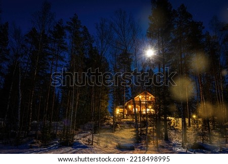 Winter fairy tale house in the middle of the snowy forest in the night