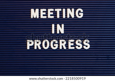 Pushboard sign that says meeting in progress in plastic letters Royalty-Free Stock Photo #2218500919