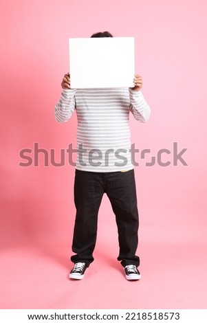 The 40s adult overweight Asian man standing on the pink background.