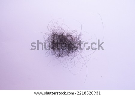 tangled hair loss isolated on white background, photo concept being dizzy or confused
