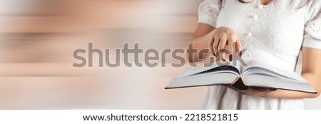 Woman reading a book while standing