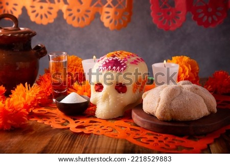 Pan de Muerto with sugar skull and Cempasuchil flowers or Marigold and Papel Picado. Decoration traditionally used in altars for the celebration of the day of the dead in Mexico Royalty-Free Stock Photo #2218529883