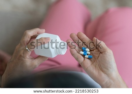 Elderly Asian Woman taking pill at home. Age, Medicine, Healthcare and People concept.