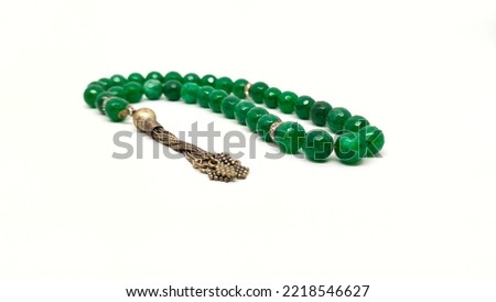 Green agate stone prayer beads tasbih on a white background  Royalty-Free Stock Photo #2218546627